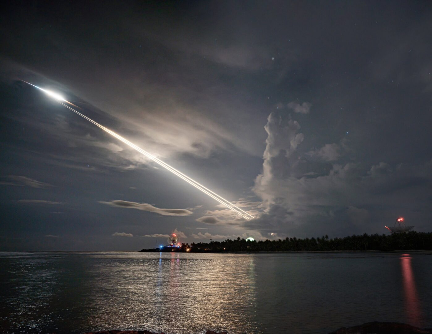 The Ronald Reagan Ballistic Missile Defense Test Site tracks an unarmed Minuteman III intercontinental ballistic missile launch. Long-exposure light trails from the light the night sky.